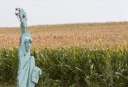 In this Aug. 1, 2012 photo, a rendition of Lady Liberty stands in front of a parched corn field near Crete, Neb. The front row of corn remains green because it is irrigated by a lawn sprinkler. The latest U.S. drought map shows that excessively dry conditions continue to worsen in the Midwest states that are key producers of corn and soybeans. This is the worst U.S. drought in decades. The weekly U.S. Drought Monitor map released Thursday, Aug. 9. 2012 shows that the area gripped by extreme or exceptional drought rose nearly 2 percent to 24.14 percent.