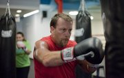 Craig Eddis participates in a boxing fitness class at Punch Boxing and Fitness, 4931 W. 6th St. Eddis attributes the class to helping him lose more than 20 pounds.