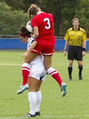 UNLV’s Caitlin Allen (3) lands on the back of Kansas’ Nicole Chrisopulos as they try to gain control of the ball during their soccer match Sunday, August 26, 2012, at the Jayhawk Soccer Complex.