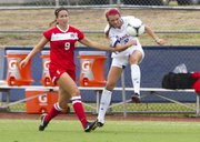 Kansas’ Haley Yearout (8) kicks the ball away from UNLV’s Jenn Wolfe (9) during their soccer match Sunday, August 26, 2012, at the Jayhawk Soccer Complex.