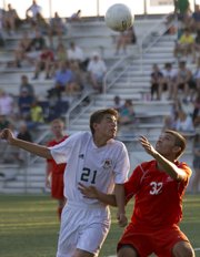 Free State's Chaska Rocha (21) and Bonner Springs' Dante Crider (32) battle for control of the ball during their soccer match Thursday, August 30, 2012, at FSHS.