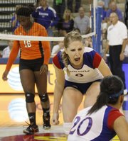 Caroline Jarmoc (9) right, celebrates with Catherine Carmichael after the Jayhawks scored the winning point against Sam Houston on Friday, Aug. 31, 2012, at Horejsi Center.