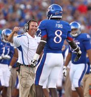 Kansas special teams coach Clint Bowen looks to hug receiver Josh Ford after Ford's blocked punt by South Dakota State in the second quarter, Saturday, September 1, 2012 at Memorial Stadium.