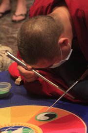 Seven Buddhist monks will be at the Spencer Museum of Art this week painstakingly constructing a sand painting called dul-tson-kyil-khor, meaning "mandala of colored powder." On Friday, the monks will toss the sand painting into Potter's Lake in a symbolic gesture.