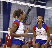 Kansas University players Tiana Dockery, left, and Tayler Tolefree celebrate Dockery's block, which earned the Jayhawks a point during the second of two sets against College of Charleston, Friday, Sept. 7, 2012 at the Horejsi Center.