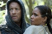 This film image released by Warner Bros. Pictures shows Tom Hanks as Zachry and Halle Berry as Meronym in a scene from “Cloud Atlas,” an epic spanning centuries and genres. )