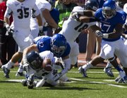 Kansas’ Schyler Miles (32) forces Rice’s Donte Moore to fumble the kickoff return during their game Saturday, Sept. 8, 2012 at Memorial Stadium.