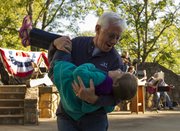 Prairie Village resident Steve Snitz dips his 6-year-old granddaughter Lela Pereira as the two dance during the Harvest Home Picnic and Music Festival on Saturday at Clinton Lake.