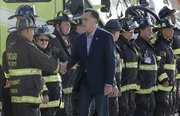 Republican presidential candidate Mitt Romney greets firefighters at Chicago O'Hare International Airport, Tuesday, Sept. 11, 2012.