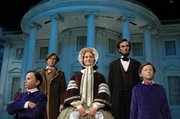 Lifelike figures of the Lincoln family stand in the Abraham Lincoln Museum Entry Plaza in Springfield, Ill.