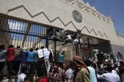 Yemeni protesters climb the gate of the U.S. Embassy during a protest about a film ridiculing Islam's Prophet Muhammad, in Sanaa, Yemen, Thursday, Sept. 13, 2012. Dozens of protesters gather in front of the US Embassy in Sanaa to protest against the American film "The Innocence of Muslims" deemed blasphemous and Islamophobic.