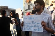 In this Wednesday, Sept. 12, 2012 photo, a Libyan man holds a placard in English during a demonstration against the attack on the U.S. consulate that killed four Americans, including the ambassador, in Benghazi, Libya. Ambassador Chris Stevens and the three other Americans died in an attack on the U.S. consulate in Benghazi by armed protesters angry over a film by a California filmmaker that ridiculed Islam's Prophet Muhammad.