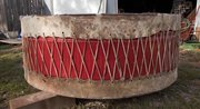 Fillmore's drum is nearly 6 ft wide and 24 inches deep made of two cow hides stretched on a metal frame of a water tank, as the sides are deadened with foam to create the deep sound.