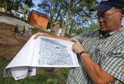 Doug Callahan, onsite supervisor with Rockhill and Associates displays a map of the stones and their placements within the structure before it was disassembled.
