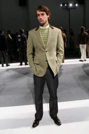 A model shows off the layered look with a white collard shirt, V-neck sweater and blazer during the Perry Ellis Fall 2005 Collection, held Feb. 4, 2005, at Byrant Park in New York.