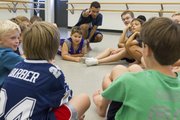 Before the start of every Athletic Movement Training for Boys and Young men class, instructor Matt Rodriguez, center, gathers his students around to get to know them better.