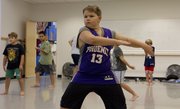 Ten-year-old Bowen Boyack, Lawrence, watches himself in a mirror as he practices his dance routine Sept. 14 in the Athletic Movement Training for Boys and Young Men class at Lawrence Arts Center, 940 N.H.