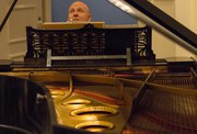 Pianist and Kansas University professor Steven Spooner performs a 20-minute concert during a release party for his 5-CD set Sept. 22 at the Spencer Museum of Art. Spooner is playing an 1886 Bechstein concert grand piano that was once owned by composer Franz Liszt.