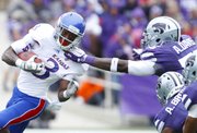 Kansas running back Tony Pierson is yanked down by the collar by Kansas State defensive end Adam Davis during the first quarter on Saturday, Oct. 6, 2012 at Bill Snyder Family Stadium in Manhattan.