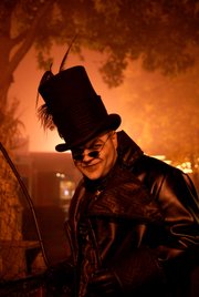A menacing "kid-catcher" carries an extra-large net while prowling the Halloween Haunt at Worlds of Fun.