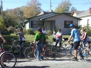 Abby Pierron, left, shows a bike tour group a location in East Lawrence where the poet Langston Hughes once lived. Pierron, education and programs coordinator for the Watkins Museum of Community History, led the group on a tour of several East Lawrence landmarks Saturday.