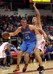 Former Oklahoma City Thunder center Cole Aldrich (45) drives on Houston Rockets' Donatas Motiejunas during an NBA preseason basketball game on Oct. 10, 2012, in Hidalgo, Texas. The Thunder sent Aldrich to the Rockets as part of the James Harden trade on Saturday night.