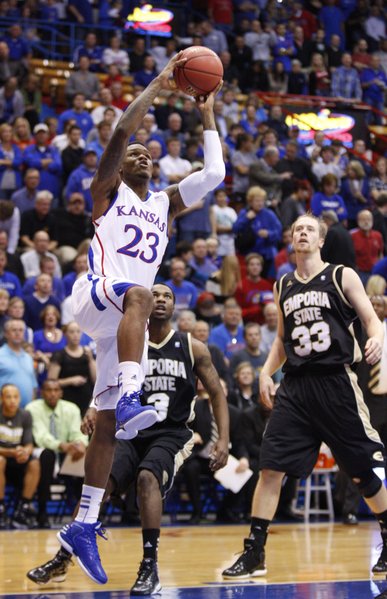 Kansas guard Ben McLemore elevates for a dunk before Emporia State players Chris Sights (3) and Michael Harris (33) during the first half, Tuesday, Oct. 30, 2012 at Allen Fieldhouse.