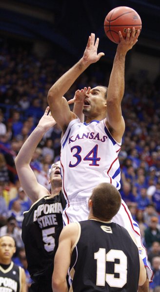 Kansas forward Perry Ellis catches a hand to the face from Emporia State forward Daniel Shaw during the first half, Tuesday, Oct. 30, 2012 at Allen Fieldhouse. Also pictured is ESU forward Michael Harris.