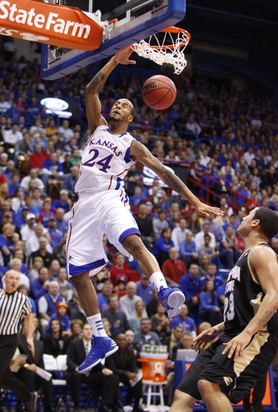 Kansas guard Travis Releford throws down a dunk before Emporia State guard Tre Boutilier during the first half, Tuesday, Oct. 30, 2012 at Allen Fieldhouse.
