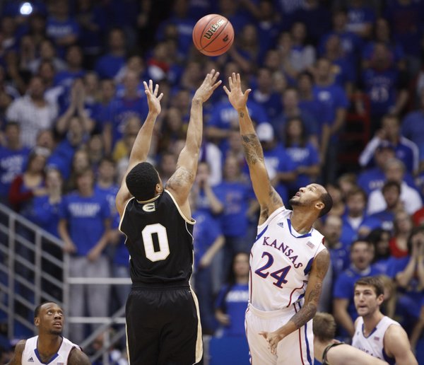 Kansas guard Travis Releford gets up to defend against a shot from Emporia State guard Kaleb Wright during the first half, Tuesday, Oct. 30, 2012 at Allen Fieldhouse.