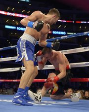 Nathan Cleverly, left, of Wales knocks down Shawn Hawk during the seventh round of their WBO light heavyweight title bout, Saturday, Nov. 10, 2012, in Los Angeles. Cleverly won in an eighth round TKO.