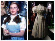 This photo combo shows, at left, actress Judy Garland as Dorothy in a scene from "The Wizard of Oz," and at right, is an Oct. 16, 2012, file photo showing the dress Garland wore in the movie, on display in London. On Sunday, Nov. 11, 2012, auction house Julien&squot;s Auctions said the gingham dress fetched the highest price of any item during a two-day auction of Hollywood memorabilia that attracted bids from around the world, selling for $480,000.