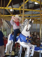 A young cowboy enjoys a ride on the 1913 Parker Carousel at the C.W. Parker Carousel Museum in Leavenworth.