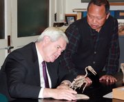 Former U.S. House Speaker Newt Gingrich examines an ichthyornis skeleton along with vertebrate paleontology collections manager Desui Miao at the KU Natural History Museum on Wednesday.