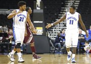 Saint Louis players Dwayne Evans, left, and Mike McCall Jr. slap hands during a run by the Billikens in the second half of the CBE Classic, Monday, Nov. 19, 2012, at the Sprint Center in Kansas City, Mo.