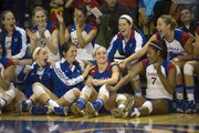 Kansas' Brianne Riley, center, is congratulated by teammates after it was announced to the crowd that the junior libero had become KU's all-time digs leader following Kansas' senior day volleyball match against Texas Tech, held Saturday, Nov. 24, 2012 at Horejsi Center. The Jayhawks made quick work of the Red Raiders, sweeping them in straight sets.