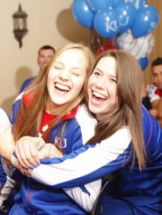 Kansas volleyball player Sara McClinton, left, is hugged by Amy Wehrs as the two watch the NCAA selection show with their teammates on Sunday, Nov. 25, 2012 in the Naismith Room at Allen Fieldhouse.