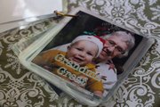 A people flip book helps a toddler recognize family and pets. Photos are labeled, laminated and put on a binder ring.