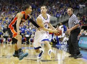 Kansas guard Evan Manning looks to pass inside against Oregon State guard Challe Barton during the first half on Friday, Nov. 30, 2012 at the Sprint Center in Kansas City, Missouri.