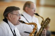 River City Reeds member Clyde Bysom, who is 93, performs along side Charles Kessinger on Nov. 30 for the preschoolers at Kids First Preschool.