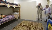 Ed Fry and Mary Ann Womack, both of Lawrence, look into one of the family rooms of the new Lawrence Community Shelter on Sunday. The shelter was open to the public for tours Sunday and plans to start fully operating by the first of the year.