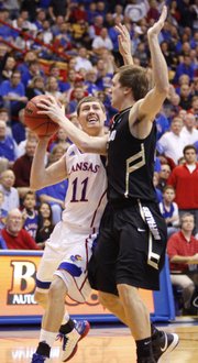 Kansas guard Tyler Self heads in for a bucket against Colorado defender Eli Stalzer during the second half on Saturday, Dec. 8, 2012 at Allen Fieldhouse.