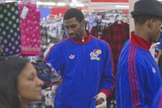 KU junior Justin Wesley sports a broken finger as he looks for gifts on Thursday, Dec. 13, 2012, during the Jayhawks' holiday shopping excursion to Wal-Mart.