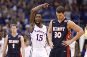 Kansas guard Elijah Johnson raises up the fieldhouse after an alley-oop dunk from center Jeff Withey against Belmont during the first half on Saturday, Dec. 15, 2012 at Allen Fieldhouse. In front is Belmont forward Trevor Noack.