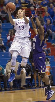 Kansas' Monica Engelman (13) floats past Kiara Etienne on her way to the basket during Kansas' game against Prairie View A&M, Sunday, Dec. 16, 2012 at Allen Fieldhouse.