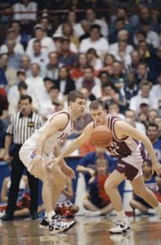 In this file photo from March 16, 1995, Kansas’ Greg Gurley, left, and Colgate’s Tucker Neale go after a loose ball during a first-round NCAA Tournament game in Dayton, Ohio.