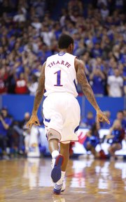 Kansas guard Naadir Tharpe signals "three" after hitting one against American during the first half on Saturday, Dec. 29, 2012 at Allen Fieldhouse.