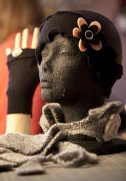 A head warmer, fingerless glove and scarf by Jerry Dowdle of Lawrence. Dowdle upcycles sweaters and other clothing items by deconstructing them and creating new clothes and accessories.