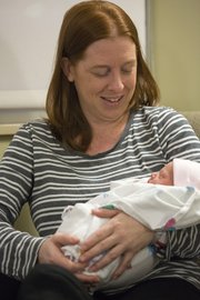 Marjorie Baker holds newborn daughter Alexis in her room at Lawrence Memorial Hospital on Tuesday. Alexis, born at 2:51 a.m., was the first baby born in Lawrence in 2013.