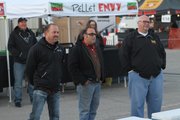 Tonganoxie resident Tim Grant (left) of Truebud BBQ; Jeff "Stretch" Rumaner of Grinders, Kansas City, Mo.; and Rod Gray of Pellet Envy, Leawood, assemble in front of coolers during filming for the Kansas City episode of "BBQ Pitmasters." Grant&squot;s teammate Boyd Abts, Eudora, is behind him. The episode premiers at 8 p.m. Central time Sunday, Jan. 6, 2013.